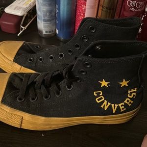 Black and yellow converse high tops